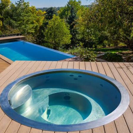 stainless steel built‑in spa pool with wood surround